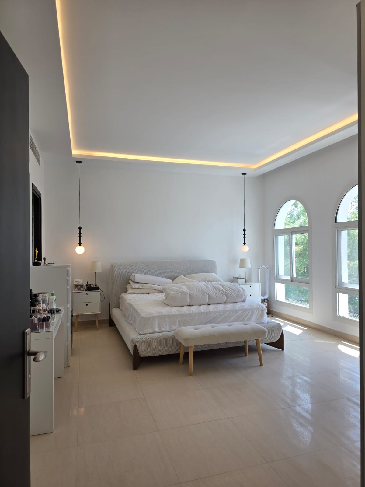 Villa Project — Umm Suqeim, Dubai: primary bedroom with arched windows